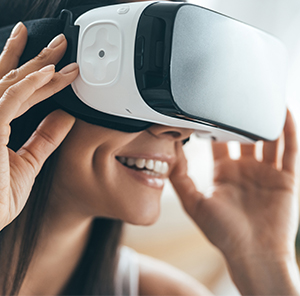 smiling woman wearing virtual reality glasses